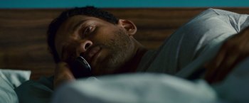 Movie still from “Seven Pounds” (2008), directed by Gabriele Muccino – A person talking on a cell phone; Close Up shot, High angle