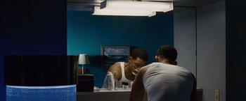 Movie still from “Seven Pounds” (2008), directed by Gabriele Muccino – A man is shaving in the mirror in a bathroom; Medium shot, Over the shoulder angle