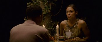 Movie still from “Seven Pounds” (2008), directed by Gabriele Muccino – A woman sitting at a dinner table with a man; Medium shot, Over the shoulder angle