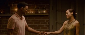 Movie still from “Seven Pounds” (2008), directed by Gabriele Muccino – A man and a woman shaking hands in front of a brick wall; Medium shot, Over the shoulder angle
