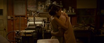 Movie still from “Seven Pounds” (2008), directed by Gabriele Muccino – Two women hugging in a restaurant kitchen; Medium shot, High angle