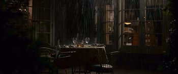 Movie still from “Seven Pounds” (2008), directed by Gabriele Muccino – A table set up for dinner in the rain; Wide shot, High angle