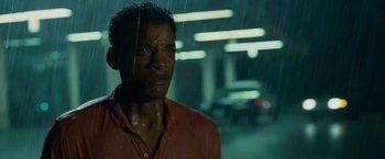 Movie still from “Seven Pounds” (2008), directed by Gabriele Muccino – A man standing in front of a window in the rain; Close Up shot, Low angle