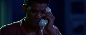 Movie still from “Seven Pounds” (2008), directed by Gabriele Muccino – A man holding a phone up to his ear; Close Up shot, High angle