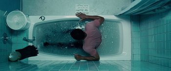 Movie still from “Seven Pounds” (2008), directed by Gabriele Muccino – A man in a pink shirt is in a bathtub; Medium shot, Overhead angle