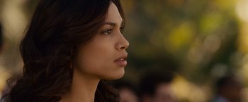 Movie still from “Seven Pounds” (2008), directed by Gabriele Muccino – A woman's face in a park setting; Close Up shot, Over the shoulder angle