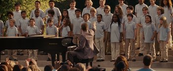 Movie still from “Seven Pounds” (2008), directed by Gabriele Muccino – A group of children singing in front of an audience; Wide shot, High angle