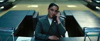 Movie still from “Severance” (2022), created by Dan Erickson – A woman sitting at a table talking on a phone; Medium shot, Low angle