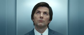 Movie still from “Severance” (2022), created by Dan Erickson – A person wearing a suit and tie; Close Up shot, Low angle