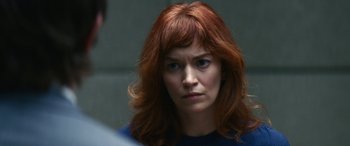 Movie still from “Severance” (2022), created by Dan Erickson – A person with red hair; Close Up shot, Over the shoulder angle