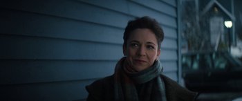 Movie still from “Severance” (2022), created by Dan Erickson – A person wearing a scarf; Close Up shot, Over the shoulder angle