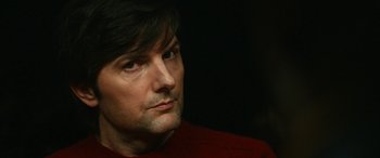 Movie still from “Severance” (2022), created by Dan Erickson – A person wearing a red shirt; Close Up shot, Over the shoulder angle