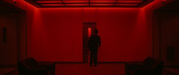 Movie still from “Severance” (2022), created by Dan Erickson – A man standing in front of an open door; Extreme Wide shot, Low angle