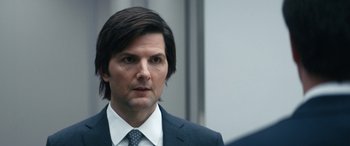 Movie still from “Severance” (2022), created by Dan Erickson – A person wearing a suit and tie; Close Up shot, Over the shoulder angle