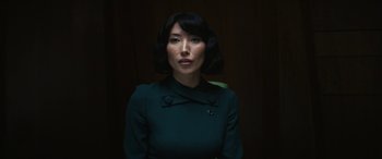 Movie still from “Severance” (2022), created by Dan Erickson – A woman in a green dress is posing for a picture; Close Up shot, Low angle