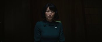 Movie still from “Severance” (2022), created by Dan Erickson – A woman with her eyes closed in a dark room; Close Up shot, Low angle