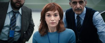 Movie still from “Severance” (2022), created by Dan Erickson – A person wearing a blue shirt; Close Up shot, Over the shoulder angle