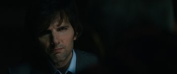 Movie still from “Severance” (2022), created by Dan Erickson – A person wearing a suit and tie; Close Up shot, Over the shoulder angle