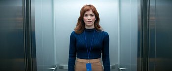 Movie still from “Severance” (2022), created by Dan Erickson – A woman standing in front of an elevator; Medium shot, Low angle