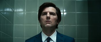 Movie still from “Severance” (2022), created by Dan Erickson – A person wearing a suit and tie; Close Up shot, Low angle