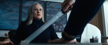 Movie still from “Severance” (2022), created by Dan Erickson – A woman holding a knife in front of a mirror; Close Up shot, Over the shoulder angle