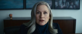 Movie still from “Severance” (2022), created by Dan Erickson – An older woman with long gray hair looking at the camera; Close Up shot, Low angle
