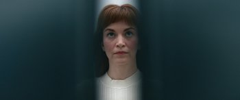Movie still from “Severance” (2022), created by Dan Erickson – A person looking at the camera; Close Up shot, Low angle