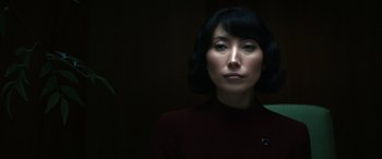 Movie still from “Severance” (2022), created by Dan Erickson – A woman in a red shirt is looking at the camera; Close Up shot, Low angle