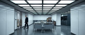 Movie still from “Severance” (2022), created by Dan Erickson – A man in a suit walking in a room; Wide shot, Low angle