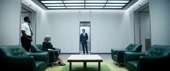 Movie still from “Severance” (2022), created by Dan Erickson – A man in a suit standing in an elevator; Wide shot, Low angle