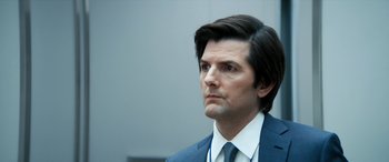 Movie still from “Severance” (2022), created by Dan Erickson – A person wearing a suit and tie; Close Up shot, Over the shoulder angle