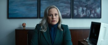 Movie still from “Severance” (2022), created by Dan Erickson – A woman with long gray hair wearing a green jacket; Close Up shot, Over the shoulder angle