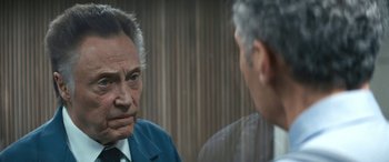 Movie still from “Severance” (2022), created by Dan Erickson – A man in a suit and tie talking to another man in a suit and tie; Close Up shot, Over the shoulder angle