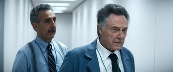 Movie still from “Severance” (2022), created by Dan Erickson – A man in a suit and tie standing next to another man in a suit and tie; Close Up shot, Low angle