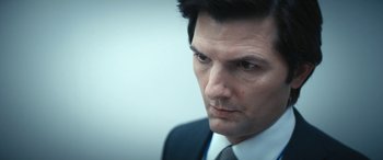 Movie still from “Severance” (2022), created by Dan Erickson – A person wearing a suit and tie; Close Up shot, Over the shoulder angle