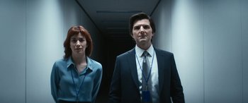 Movie still from “Severance” (2022), created by Dan Erickson – A man and a woman standing next to each other in a hallway; Medium shot, Low angle