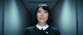 Movie still from “Severance” (2022), created by Dan Erickson – A woman in a black sweater and a white shirt; Close Up shot, Low angle