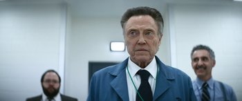 Movie still from “Severance” (2022), created by Dan Erickson – An older man wearing a suit and tie; Close Up shot, Low angle