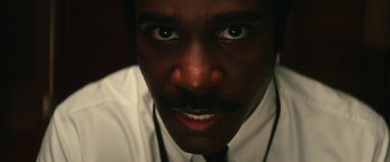 Movie still from “Severance” (2022), created by Dan Erickson – A person wearing a shirt and tie; Extreme Close Up shot, Low angle
