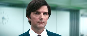 Movie still from “Severance” (2022), created by Dan Erickson – A person wearing a suit and tie; Close Up shot, Low angle