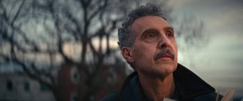 Movie still from “Severance” (2022), created by Dan Erickson – An older man with grey hair looking upward; Close Up shot, Low angle