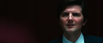 Movie still from “Severance” (2022), created by Dan Erickson – A person wearing a suit and tie; Close Up shot, Low angle