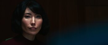 Movie still from “Severance” (2022), created by Dan Erickson – A person with short black hair; Close Up shot, Over the shoulder angle