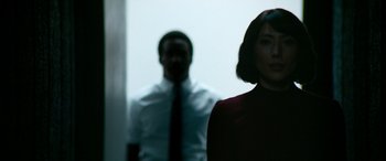 Movie still from “Severance” (2022), created by Dan Erickson – A man and a woman standing next to each other; Medium shot, Over the shoulder angle