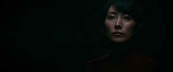 Movie still from “Severance” (2022), created by Dan Erickson – A woman with short black hair is standing in the dark; Close Up shot, Low angle