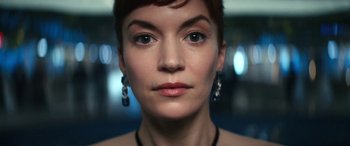 Movie still from “Severance” (2022), created by Dan Erickson – A woman's face with a lot of makeup on; Close Up shot, Low angle