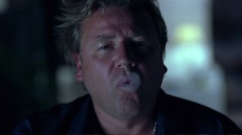 Movie still from “Sexy Beast” (2000), directed by Jonathan Glazer – A person smoking a cigarette; Close Up shot, Low angle