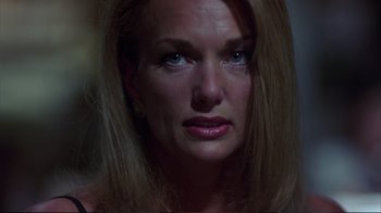 Movie still from “Sexy Beast” (2000), directed by Jonathan Glazer – A person with long blonde hair; Close Up shot, Low angle