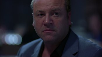 Movie still from “Sexy Beast” (2000), directed by Jonathan Glazer – A person wearing a suit and tie; Close Up shot, Low angle