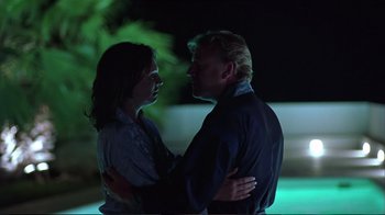 Movie still from “Sexy Beast” (2000), directed by Jonathan Glazer – A man and a woman embracing each other in the dark; Medium shot, Low angle